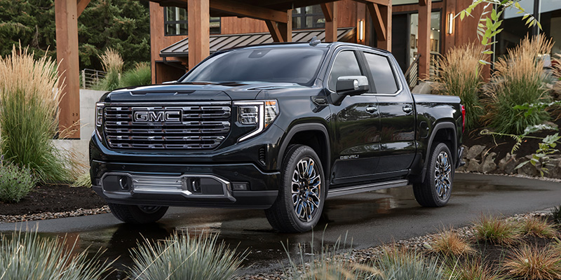 Black GMC Sierra Denali Ultimate parked in a driveway