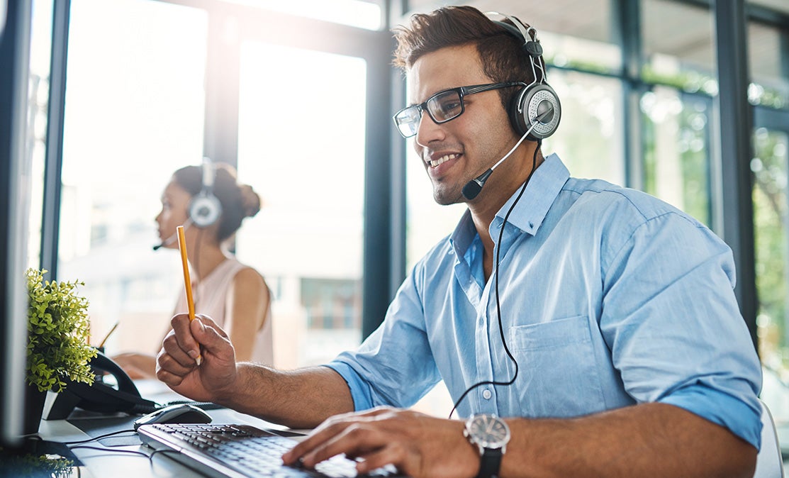 Man wearing headphones in call center